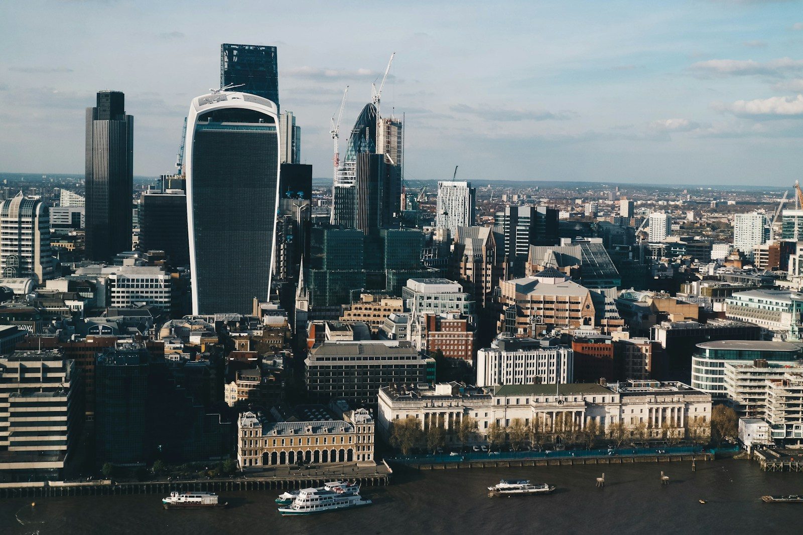 City of London skyline in evening light, with the Walkie Talkie tower and the Thames